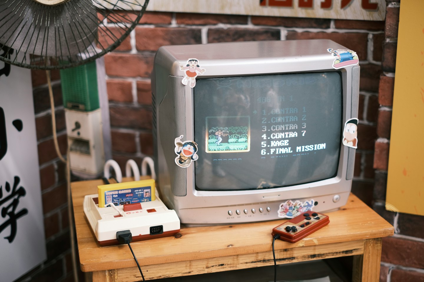 Vintage gaming console and CRT television sit on a wooden table.